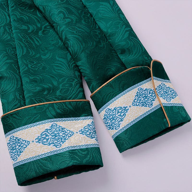 Emerald green sleeves with ornate blue and white embroidered cuffs.