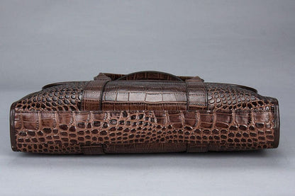 Brown crocodile leather briefcase with textured scales and a handle.