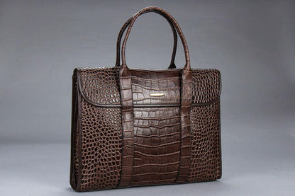 Brown leather briefcase with a crocodile skin pattern.