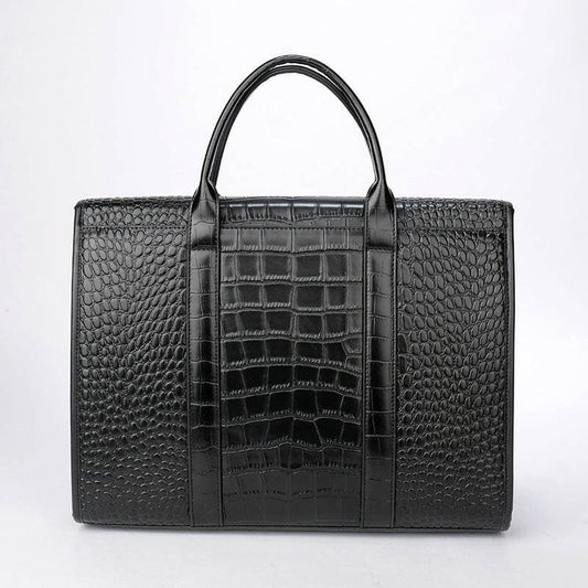 Black leather briefcase with crocodile-textured panels and handles.