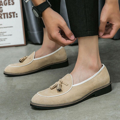 Beige suede loafer with a tassel detail on the upper.