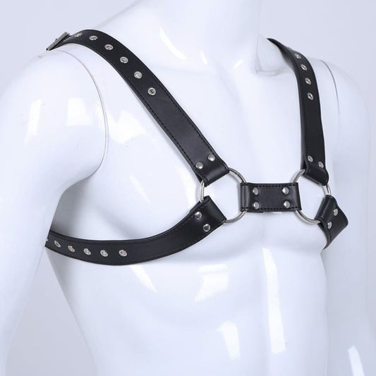 Black leather harness with metal rings and studs worn on a mannequin torso.