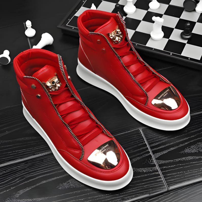 Pair of bright red high-top sneakers with gold metallic toe caps and zipper detailing.