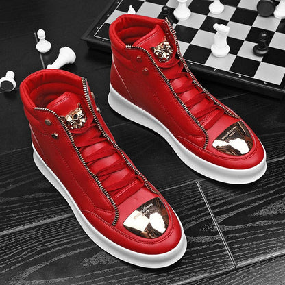 Pair of bright red high-top sneakers with metallic gold toe caps and decorative zippers.