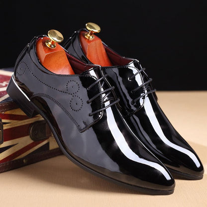 Shiny black patent leather dress shoes with laces.