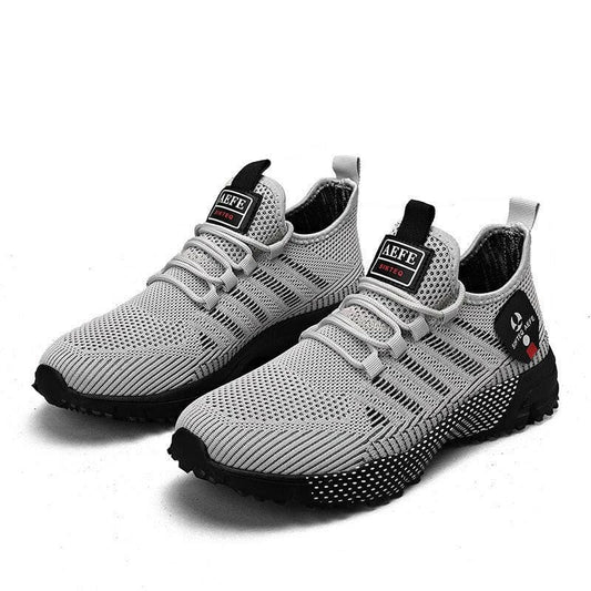 Pair of light gray athletic sneakers with black accents and a knit mesh upper.