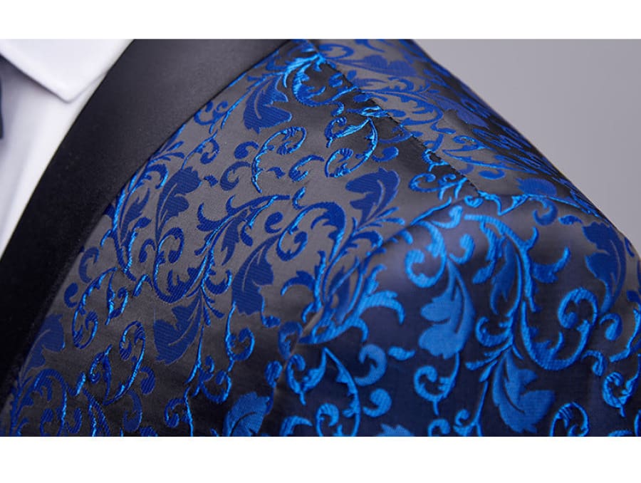 Vibrant blue and black patterned silk necktie with an ornate floral design.