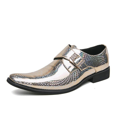 Metallic silver dress shoe with a snakeskin-like pattern and buckle strap.