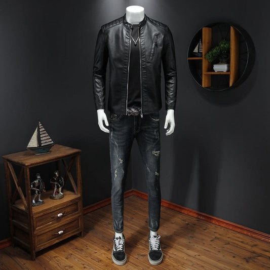 Black leather jacket displayed on a mannequin with jeans and sneakers.