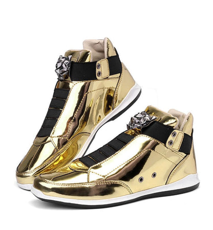 Pair of shiny gold high-top sneakers with black straps and metallic embellishments.