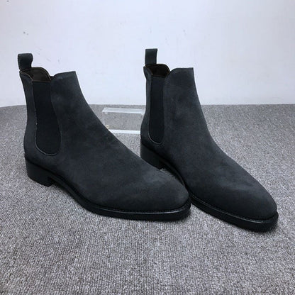 Pair of black suede Chelsea boots with elastic side panels.