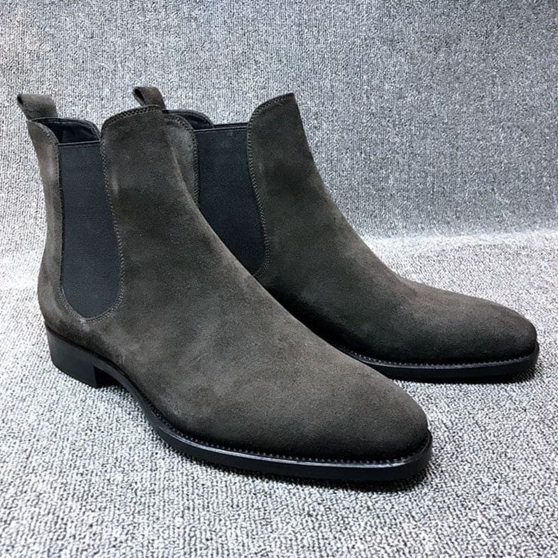 Pair of gray suede Chelsea boots with elastic side panels.