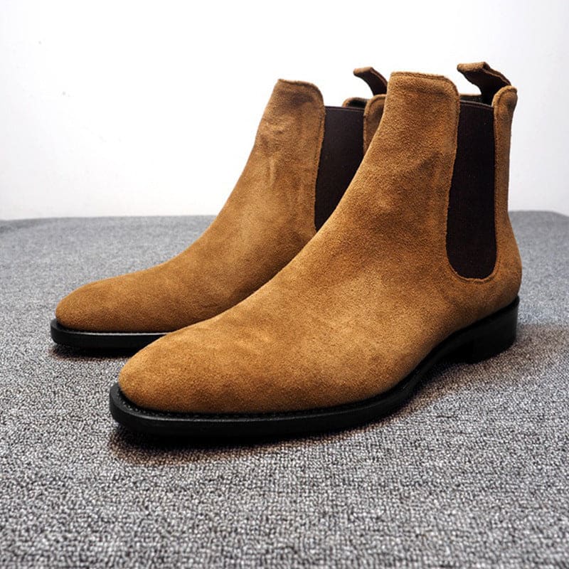 Pair of tan suede Chelsea boots with elastic side panels.