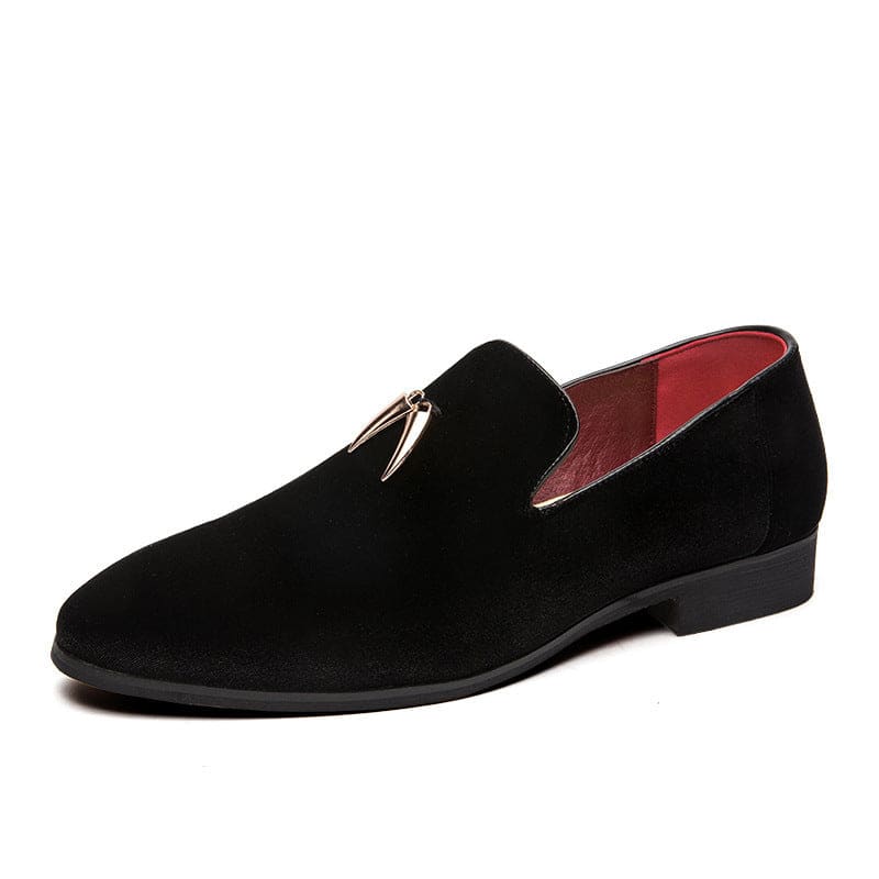 Black suede loafer with a gold tassel ornament.