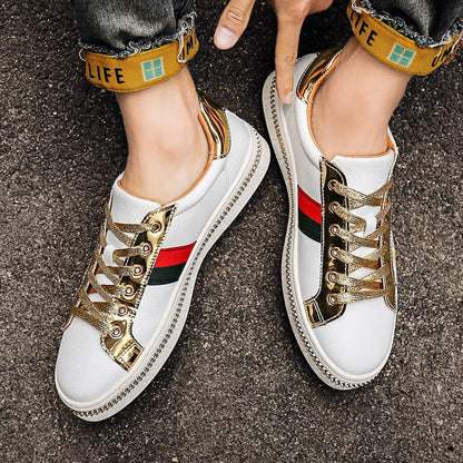 Pair of white sneakers with gold accents, red and green stripes, and yellow ankle straps reading ’LIFE’.