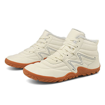 Pair of high-top cream-colored sneakers with gum rubber soles and zigzag design accents.