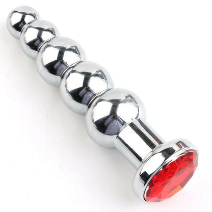 Metal anal plug with graduated spheres and a red jewel base.