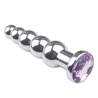 Metal anal plug with a purple jewel end.