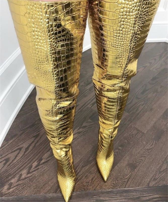 Gold metallic thigh-high boots with a crocodile skin texture and pointed toes.