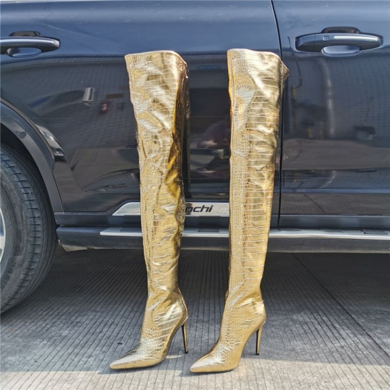 Pair of shiny gold thigh-high stiletto boots.