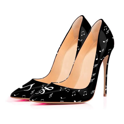 Pair of black high-heeled shoes with musical note patterns printed on them.