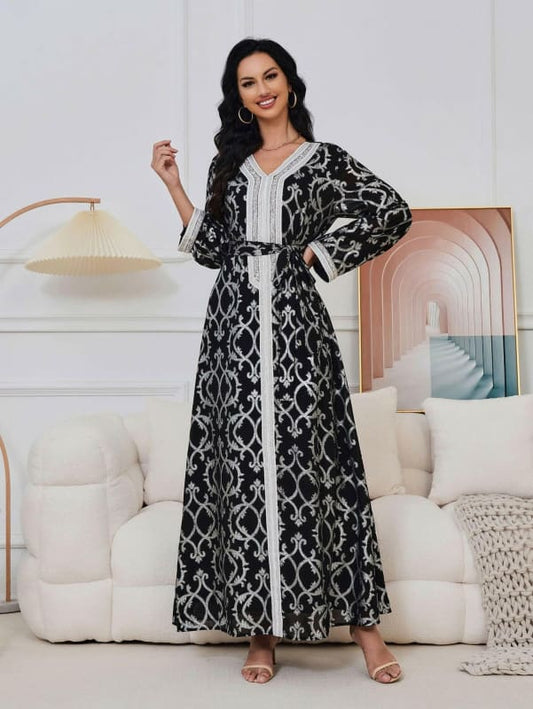 Long-sleeved maxi dress with a black and white geometric pattern and contrasting white trim.