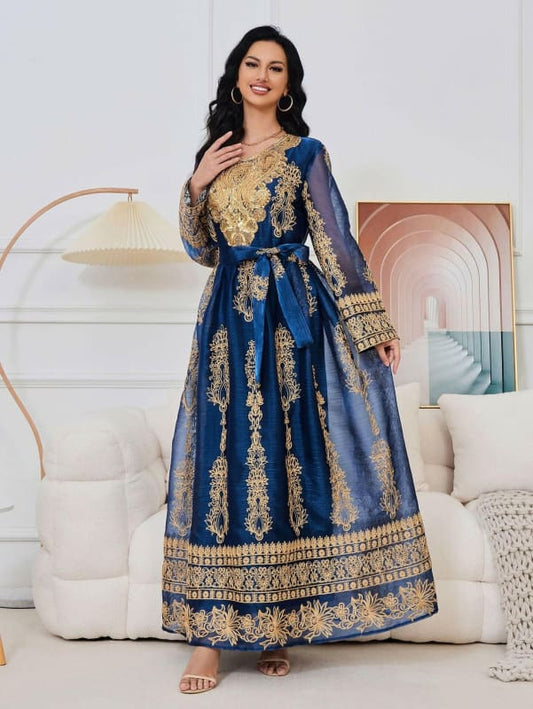 Ornate blue and gold floor-length dress with intricate embroidery and long sleeves.