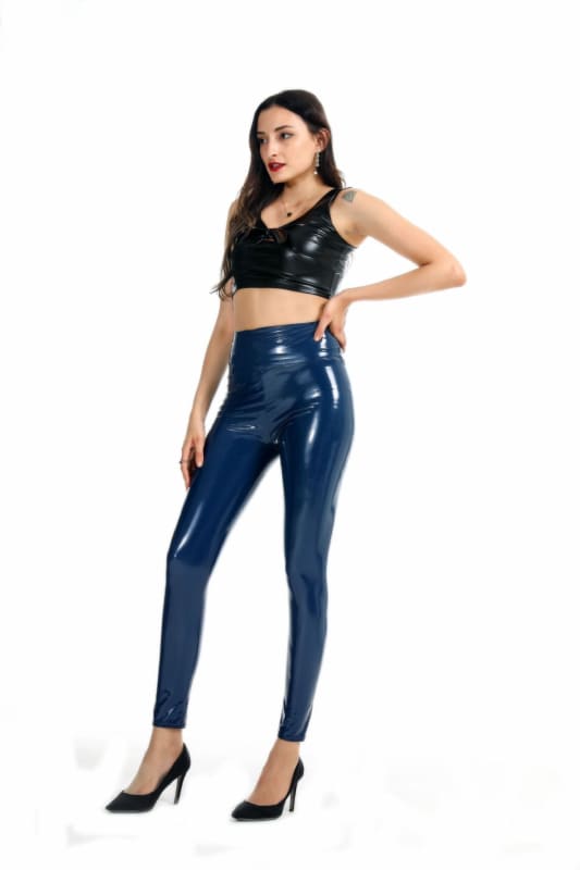 Woman wearing shiny blue leggings and a black crop top.