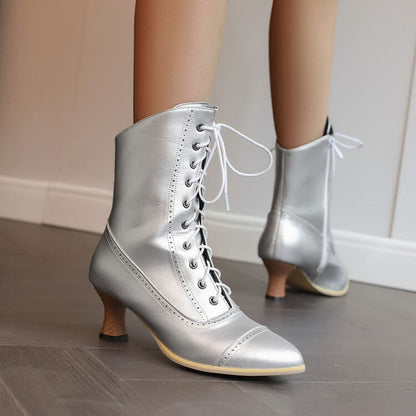 Silver lace-up ankle boots with pointed toes and low heels.