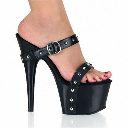 Black platform high heel sandal with studded straps.