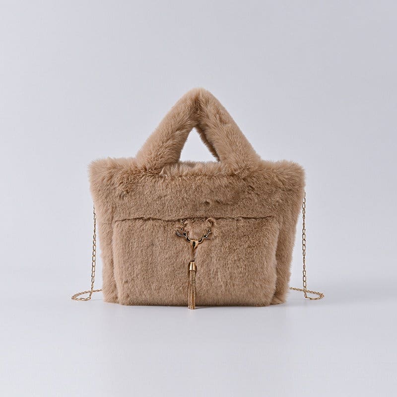 Fluffy beige handbag with a chain strap and decorative tassel.