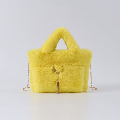 Bright yellow furry handbag with a chain strap and zipper closure.