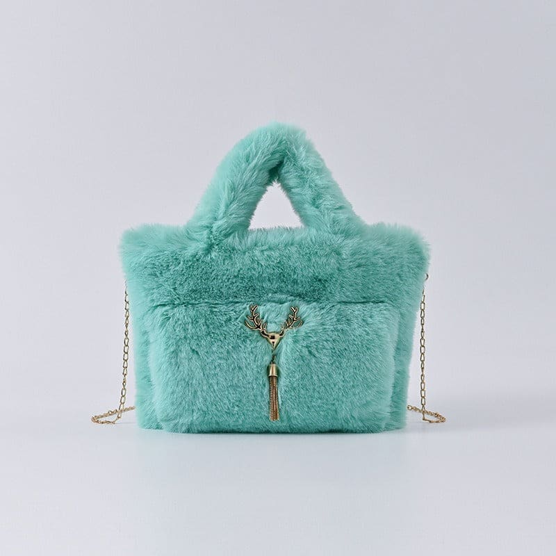 Mint green fluffy handbag with gold chain strap and decorative tassel.