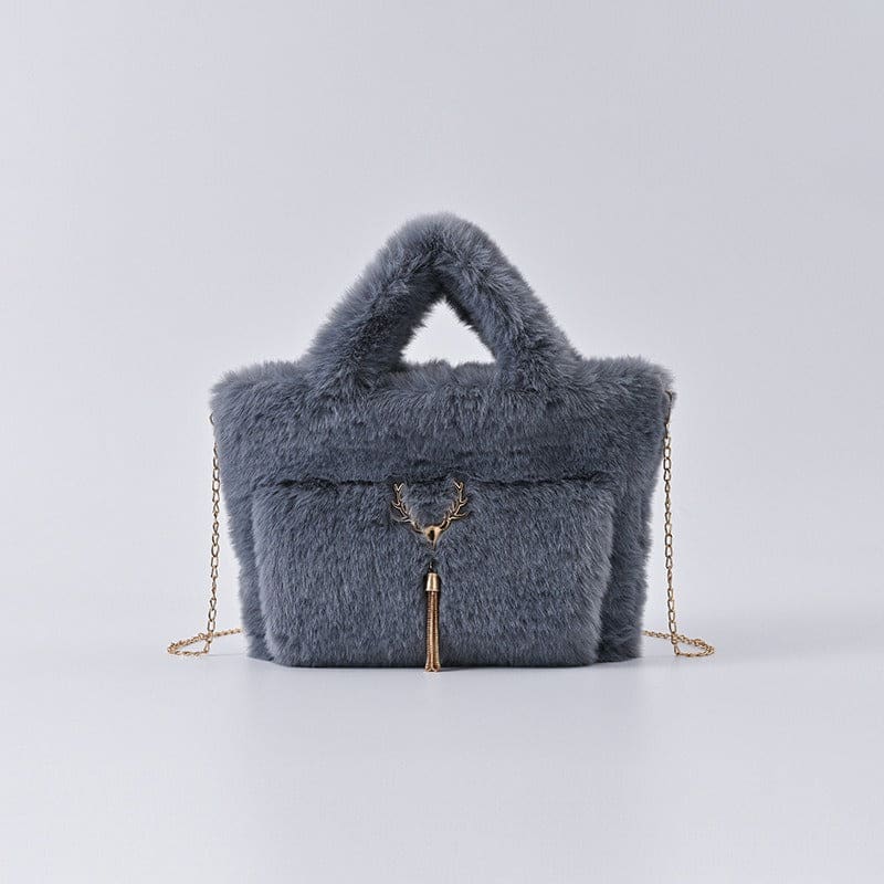 Fluffy gray handbag with a gold chain strap and tassel detail.