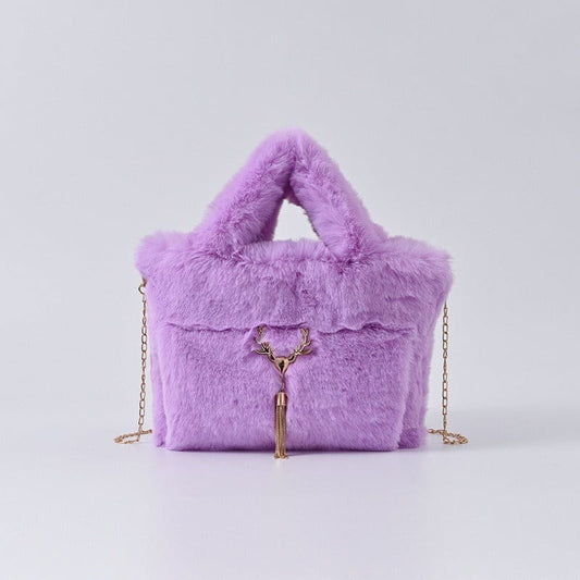 Fluffy lavender handbag with gold chain strap and tassel detail.