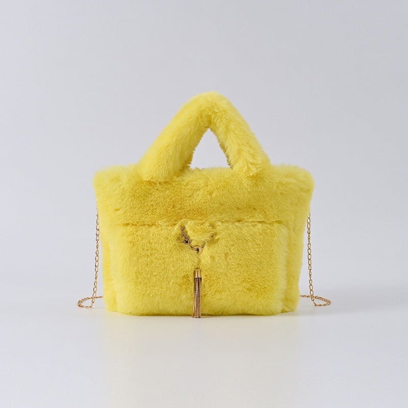 Bright yellow furry handbag with a chain strap and decorative tassel.