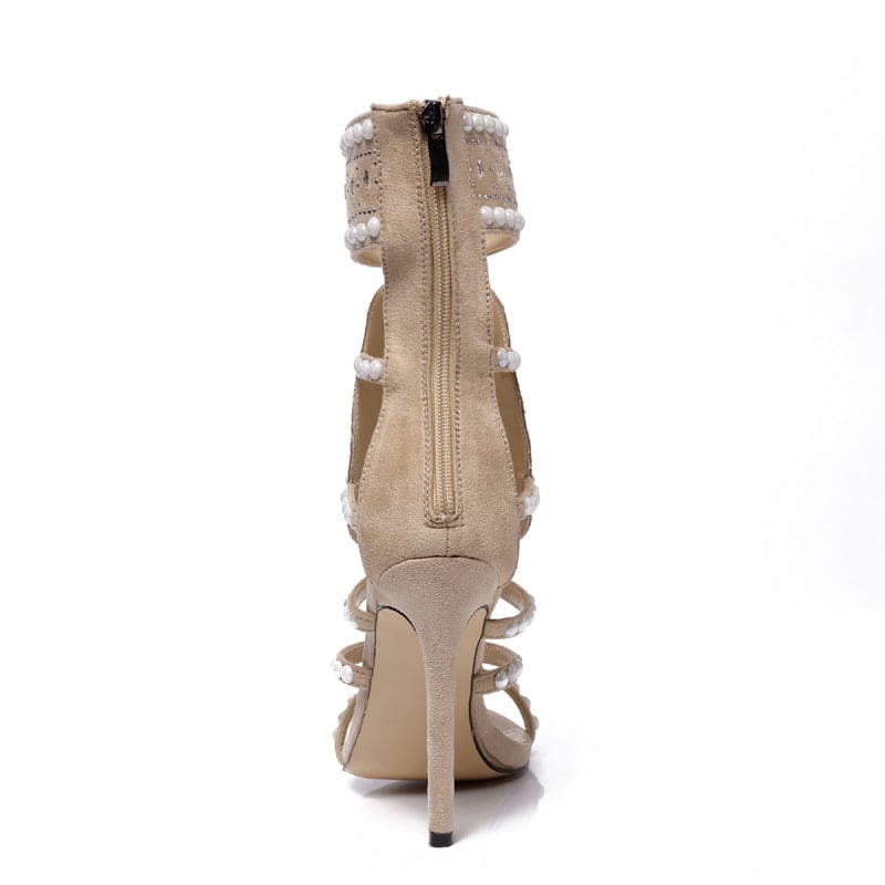 Beige high-heeled sandal with multiple straps and a back zipper.