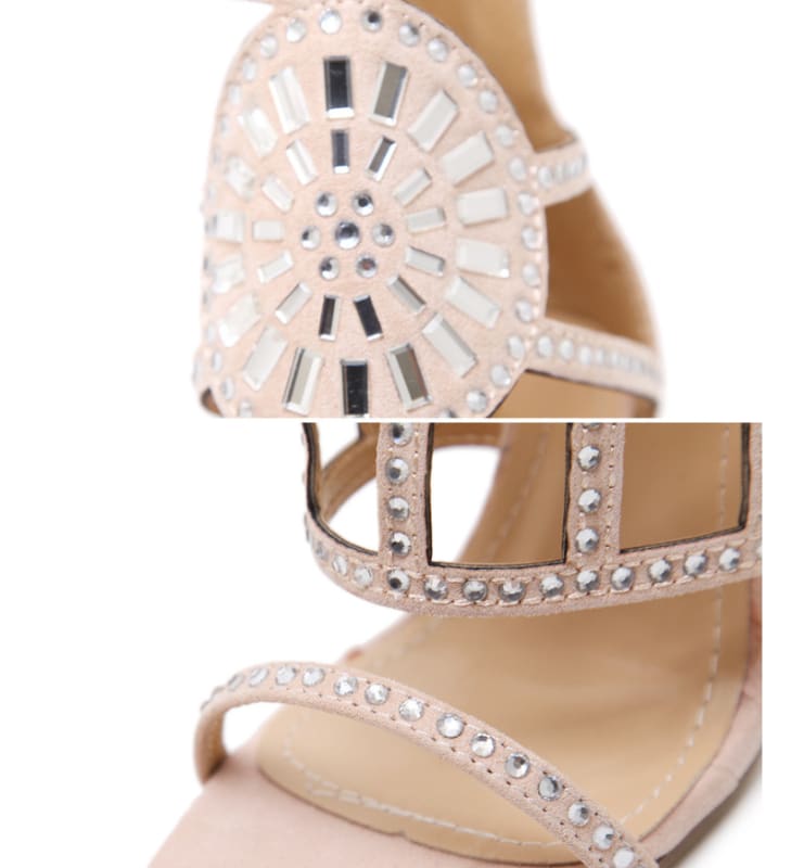 Ornate high-heeled sandal with rhinestone embellishments and cutout design.