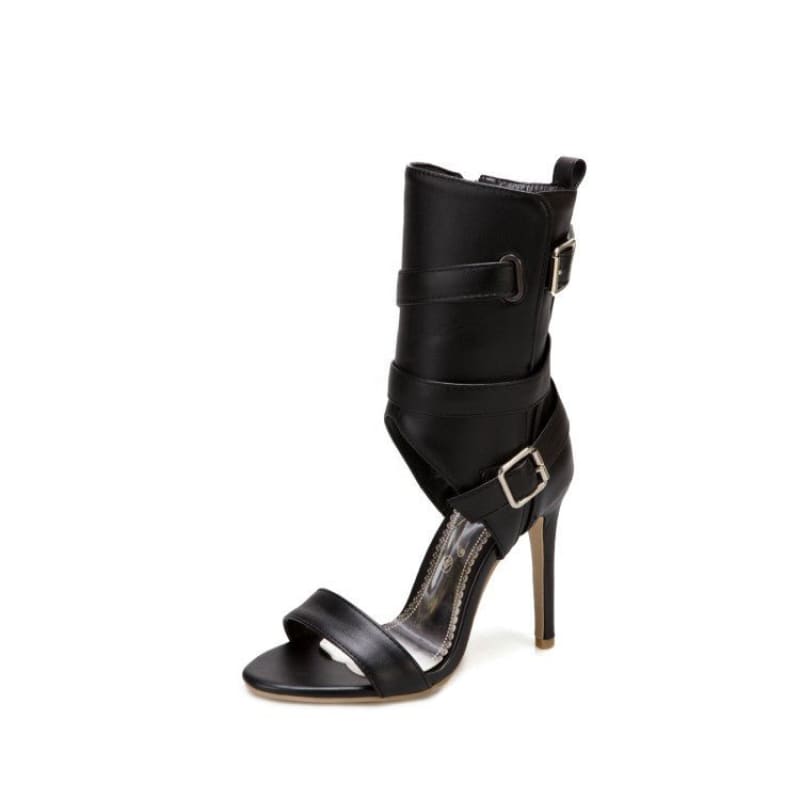 Black leather high-heeled sandal with multiple buckled straps.