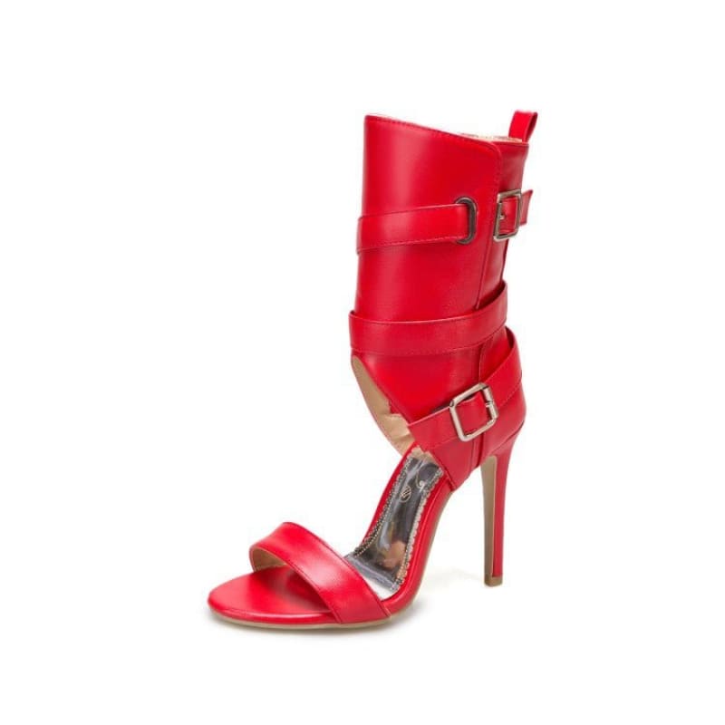 Red high-heeled sandal with ankle straps and buckles.