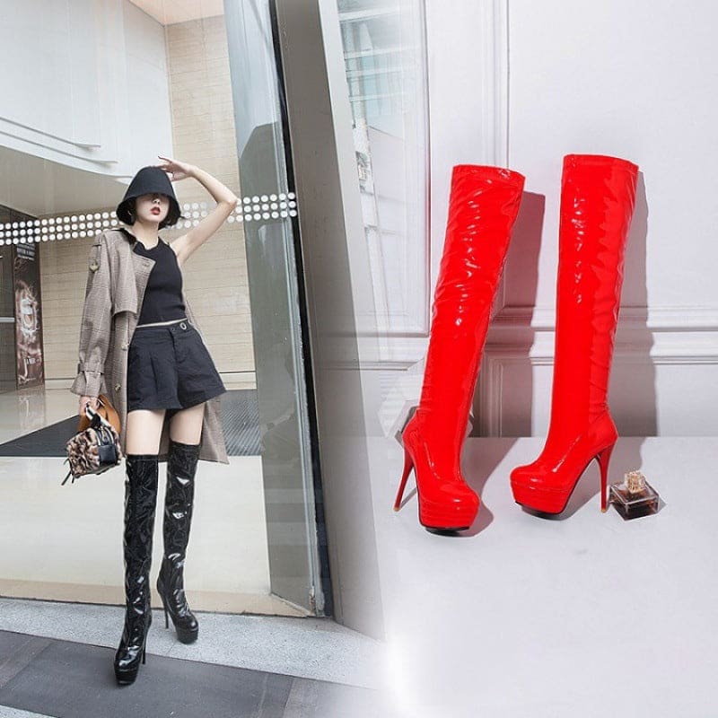 Pair of bright red thigh-high stiletto boots with platform soles.