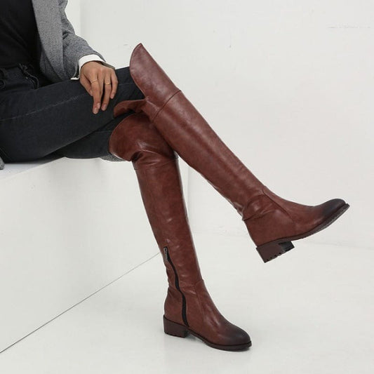 Pair of knee-high brown leather boots with low heels.