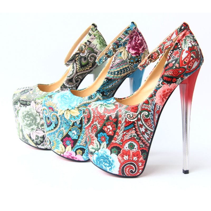 Three ornate high-heeled platform shoes with colorful floral and paisley patterns.