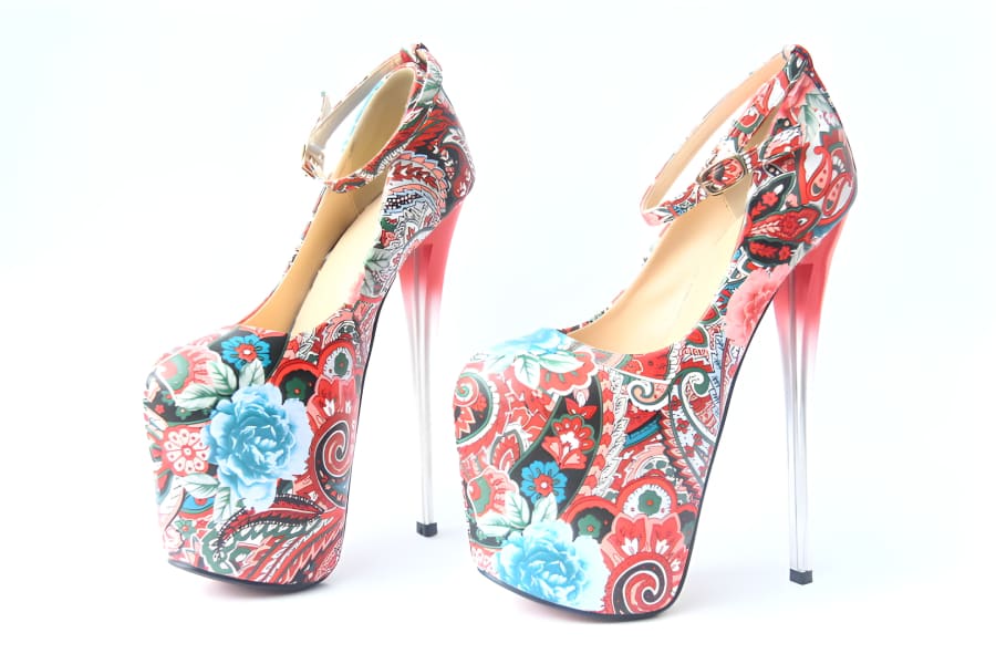 Pair of floral-patterned platform stiletto heels with extremely high, thin metal heels.