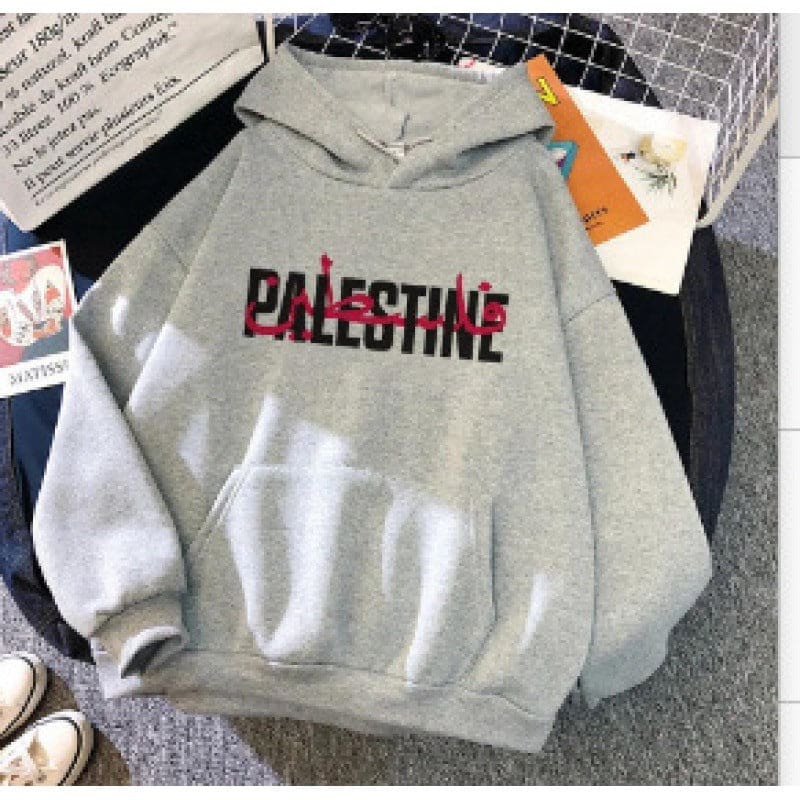 Gray hoodie sweatshirt with ’PALESTINE’ printed on the front in black and red lettering.