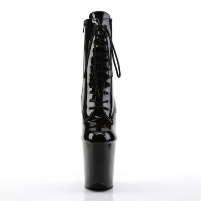 Shiny black patent leather platform boot with extremely high heel and lace-up front.