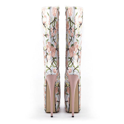 Pair of high-heeled boots with floral embroidery design.