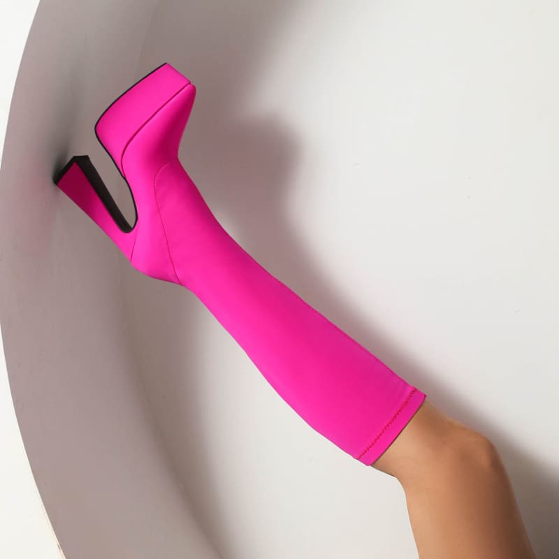 Hot pink thigh-high platform boot worn on a leg.