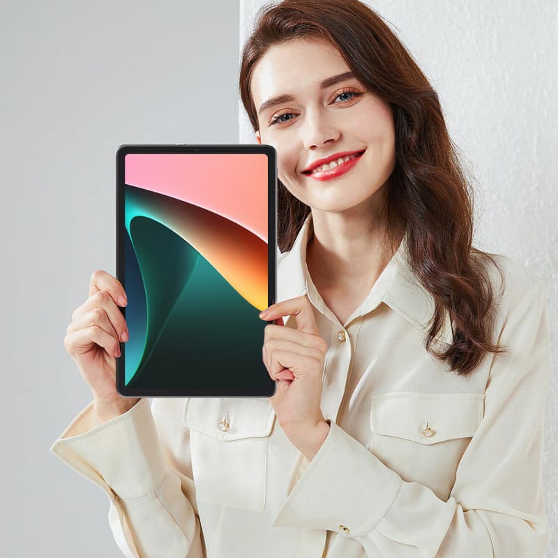 Tablet device with a colorful abstract display being held by a smiling woman in a white shirt.