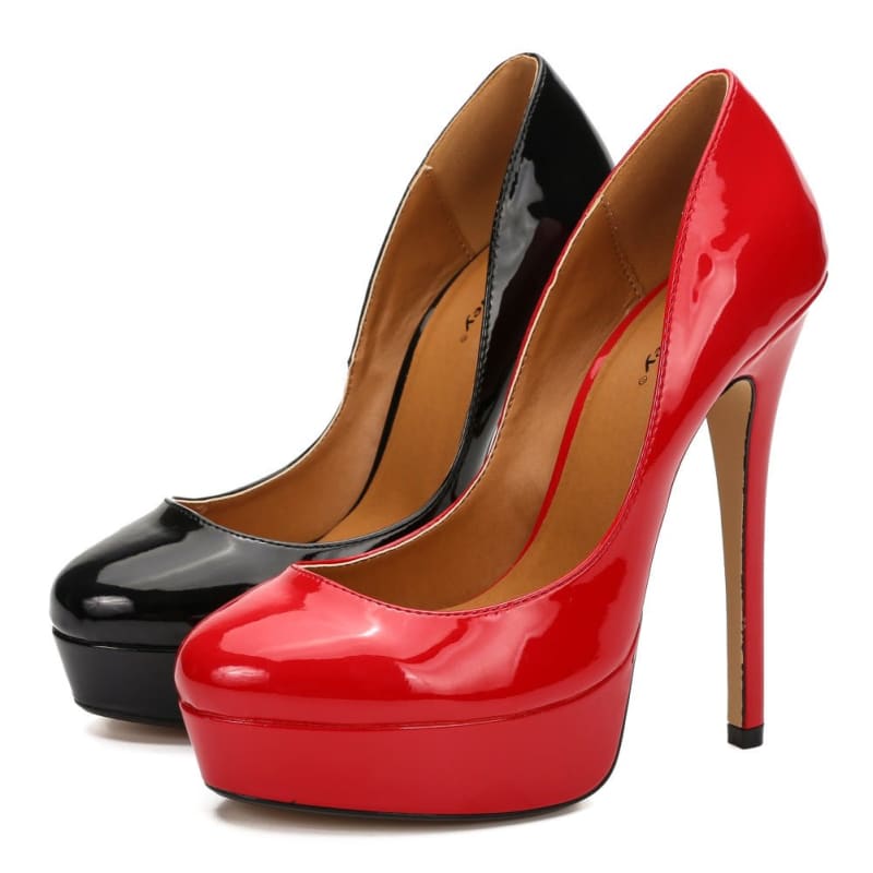 Pair of high-heeled platform pumps in black and red patent leather.